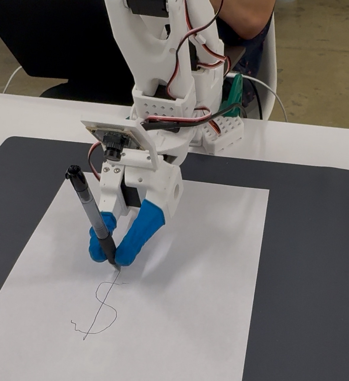 SO-100 robot arm drawing a dollar sign